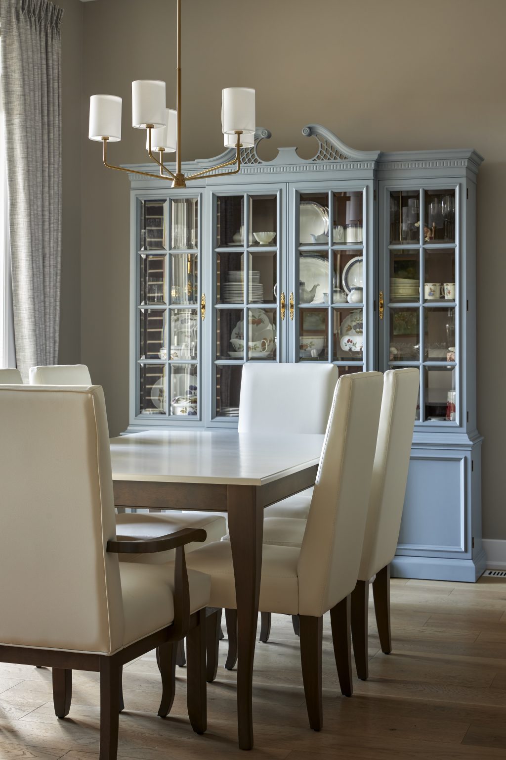 Blue china cabinet in modern dining room